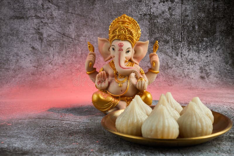 idol-lord-ganesha-modak-sweet-dish-flower-ganesh-chaturthi-255069677.jpg